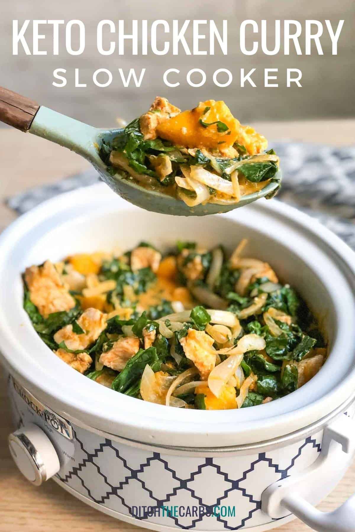 keto chicken curry served with spinach being served with a wooden spoon