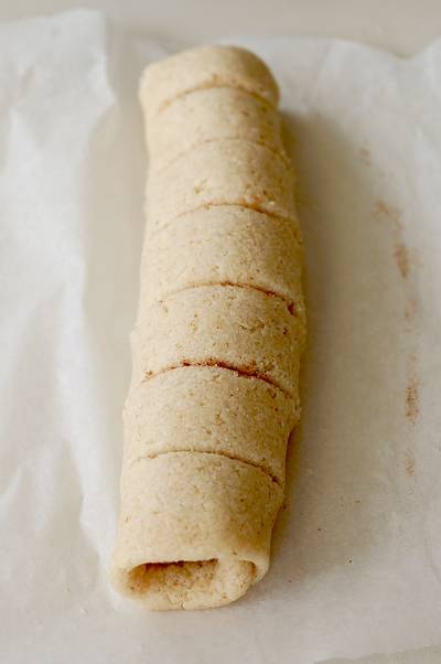rolled out Chelsea bun bread dough on baking parchment cut into slices