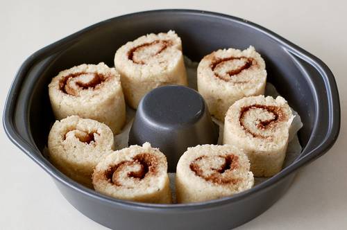 cinnamon rolls cut and placed in a ring tin ready to bake