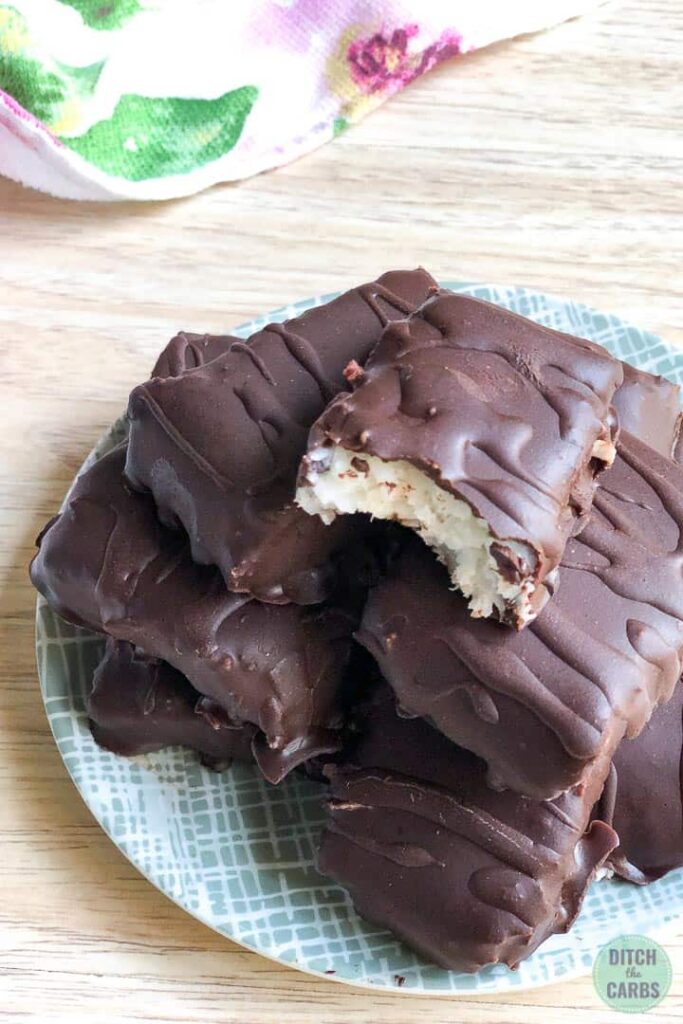 chocolate coated keto bounty bars with a bite taken
