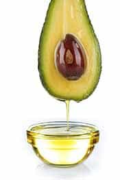 A close up of an avocado dripping in oil