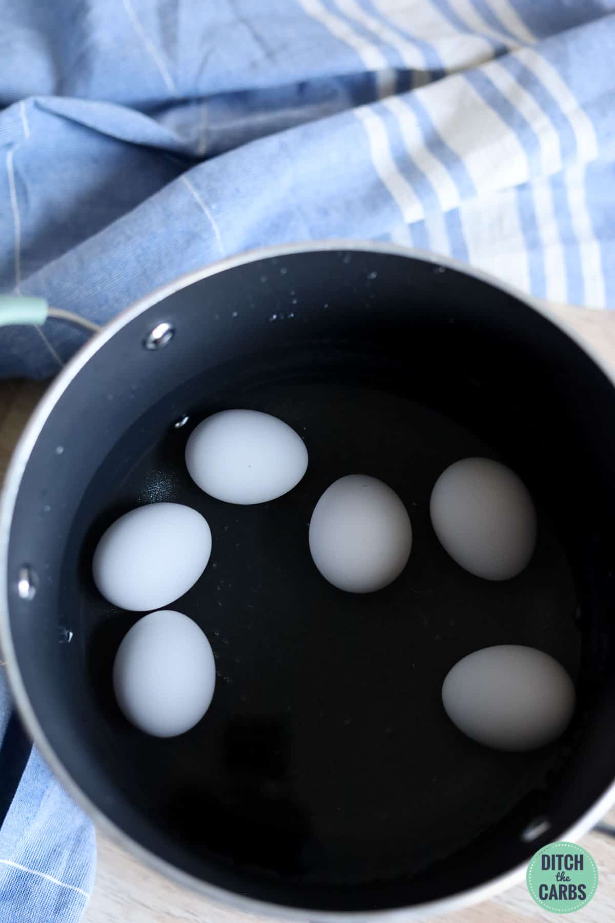 eggs boiling in water in a large saucepan