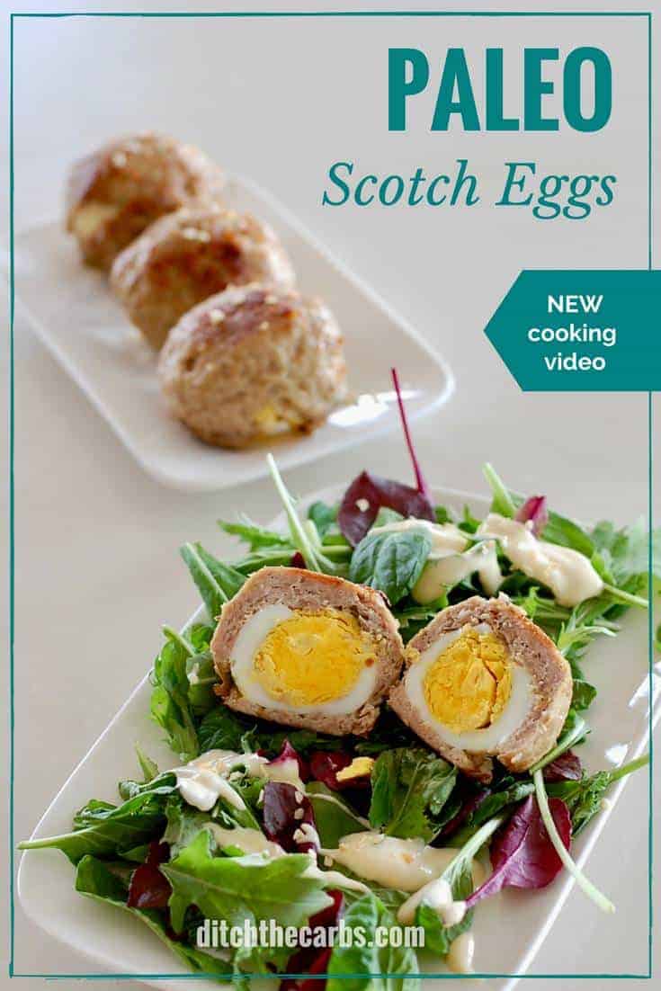 A plate of food, with a scotch egg sitting on salad