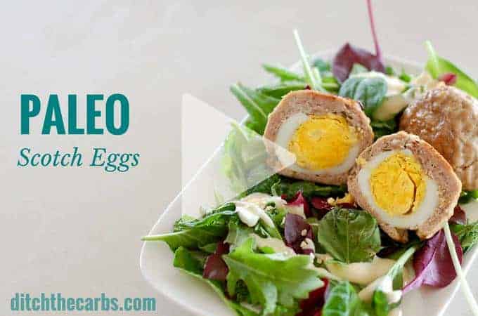 Paleo scotch eggs served on salad drizzled with mayonnaise