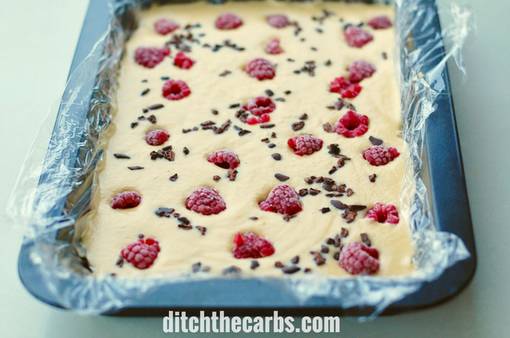 Low carb ice cream bars setting in a lined baking dish in the freezer