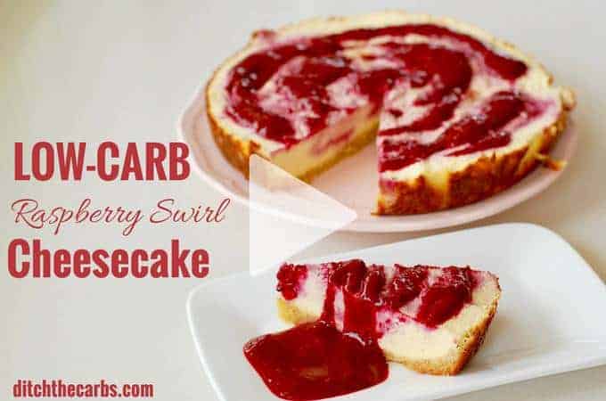 low-carb raspberry swirl cheesecake sliced and on a cake stand