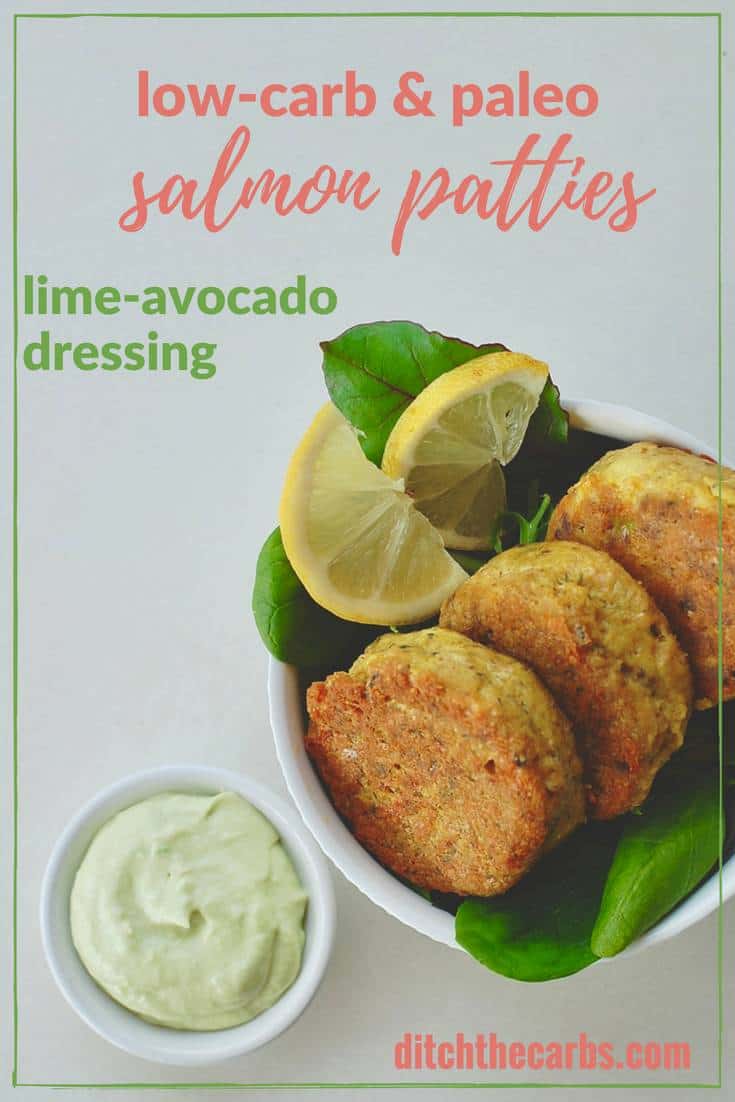 salmon patties with lime avocado dressing served in a white bowl with baby spinach