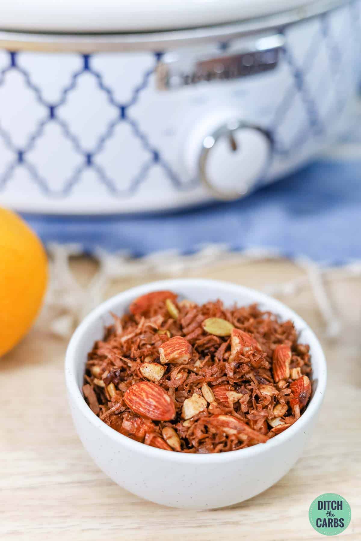 chocolate granola with a slow-cooker in the background