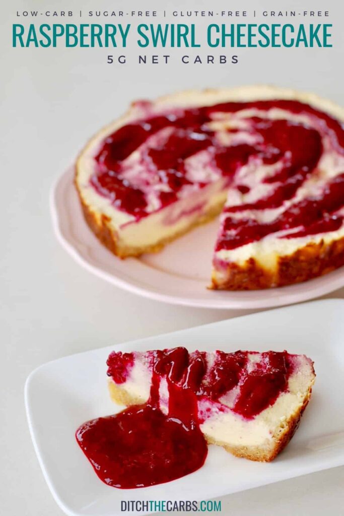 A slice of cheesecake with raspberry swirls on a white plate in the foreground and a whole cheesecake in the background