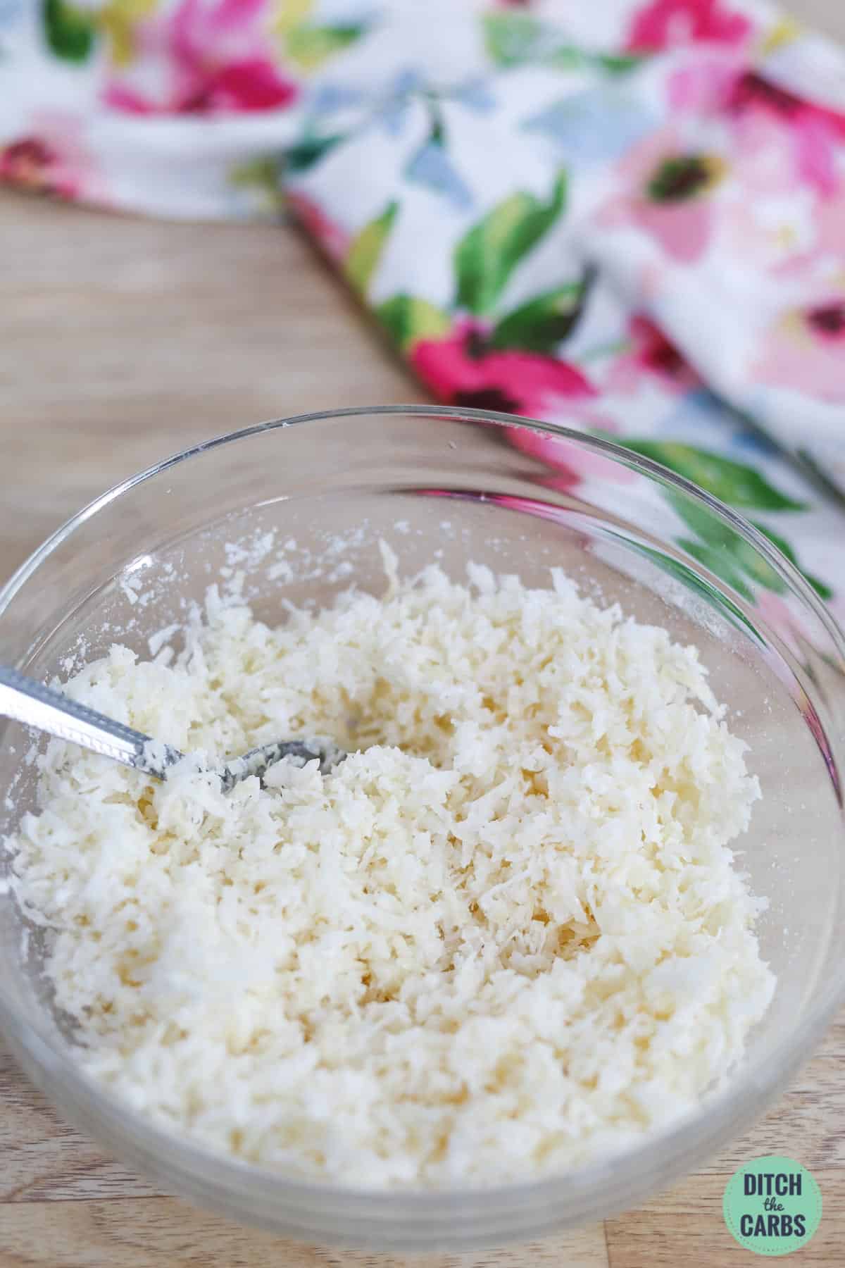 a mixing bowl of desiccated coconut and coconut oil