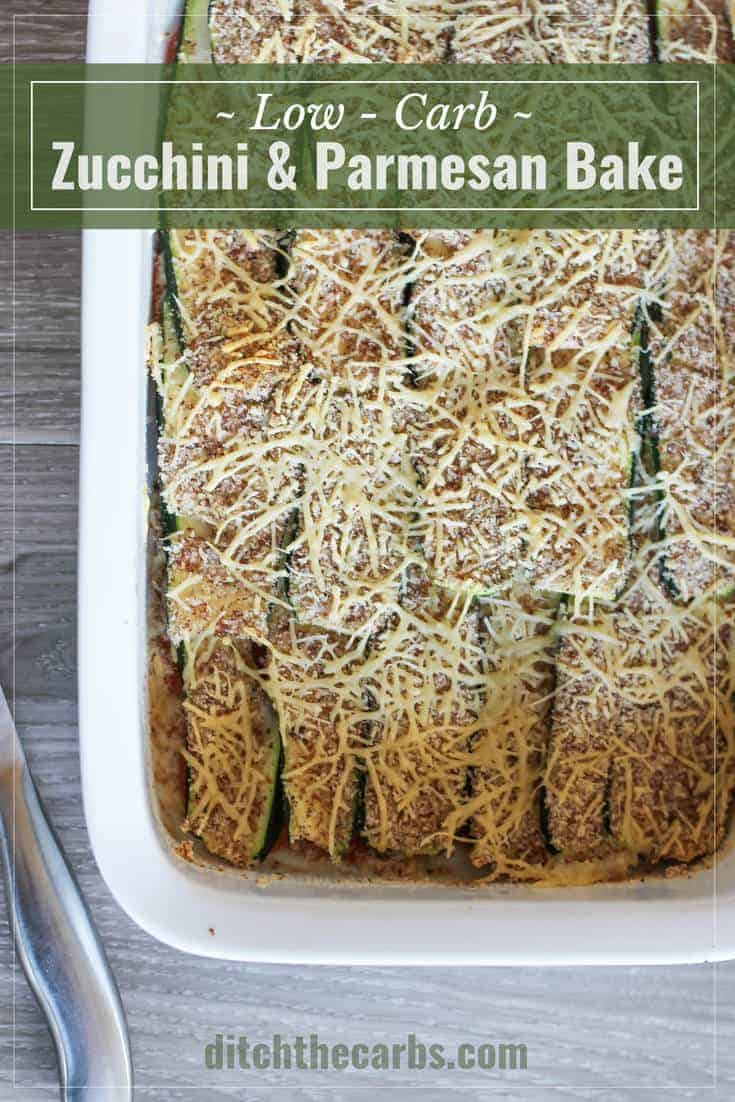sliced zucchini in a baking dish covered with shredded parmesan and ground almonds