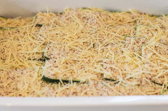 Sliced courgette covered in almond flour crust and shredded cheese