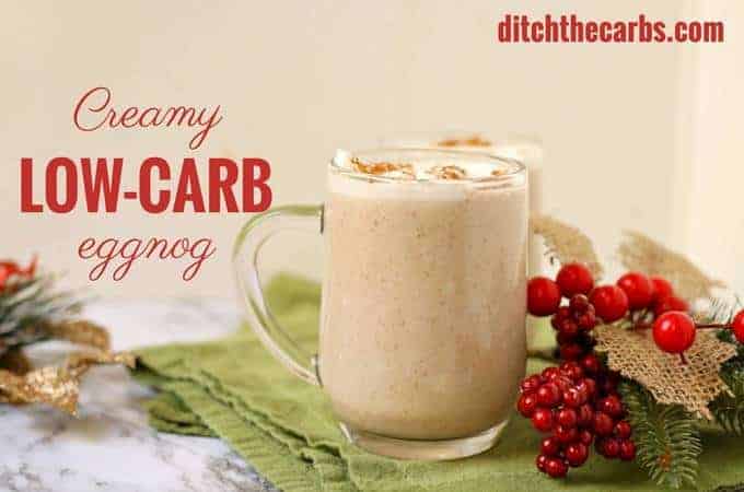 Low-carb creamy eggnog garnished with nutmeg and Christmas decorations and a green cloth