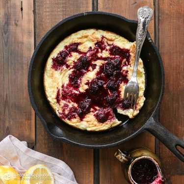 A berry pancake cooked in a frying pan