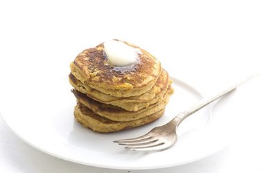 A pile of pancakes and melted butter