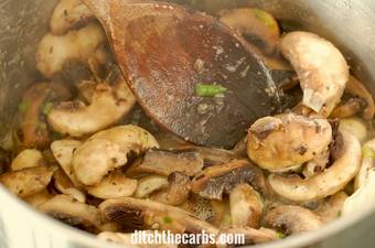A dish is filled soup and mushrooms