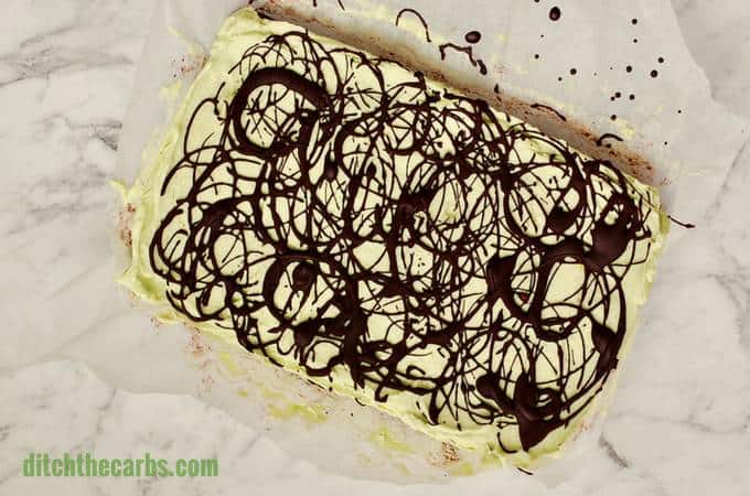 No Bake Chocolate Peppermint Cheesecake Squares on a marble chopping board