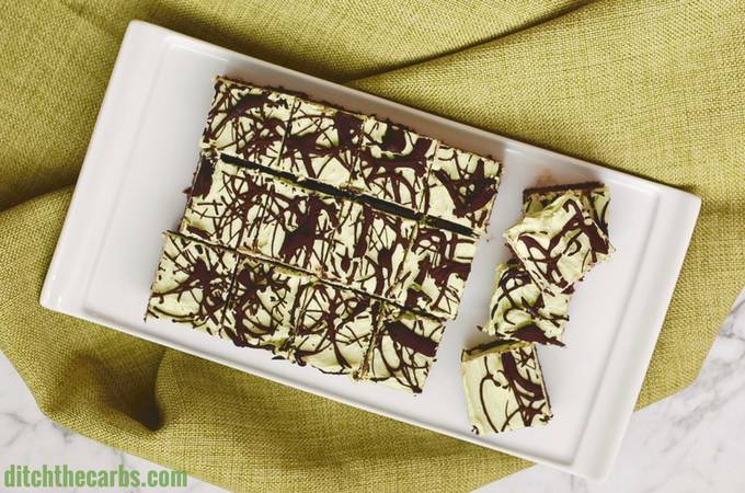 No Bake Chocolate Peppermint Cheesecake Squares served on a white dish with a green napkin