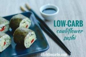 low-carb cualiflower sushi on a plate with soy sauce on side