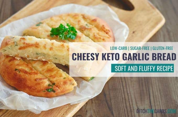 cheesy keto garlic bread sliced on baking parhchment and a bread board