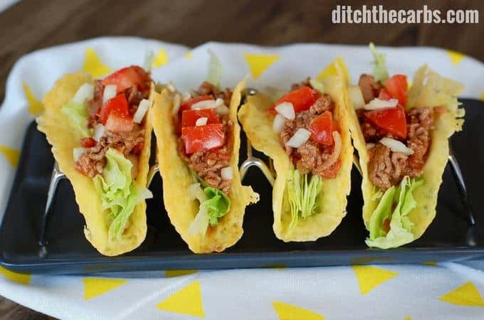 A plate of cheese taco shells filled with lettuce and ground beef