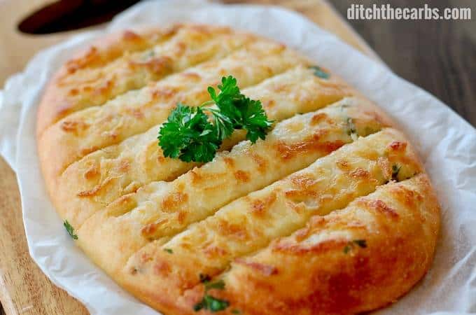 cheesy garlic bread on a cutting board