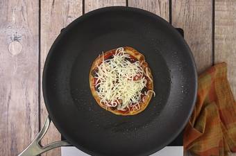 A close up of a pan-frying the pizza pancakes