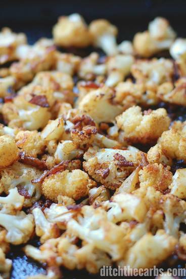 A close up of cauliflower popcorn in a baking tray
