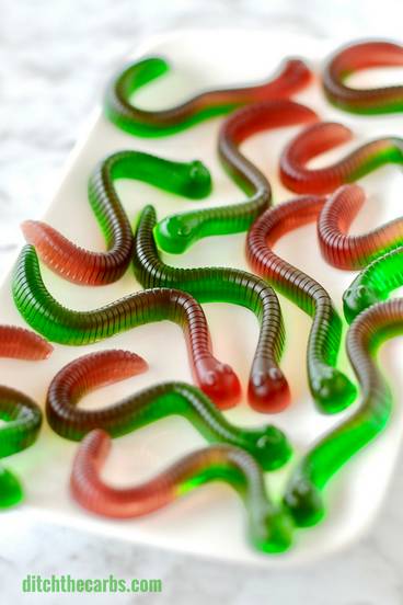Fully set sugar-free gummy worms served on a white platter