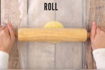 Roling the dough with a wooden roller