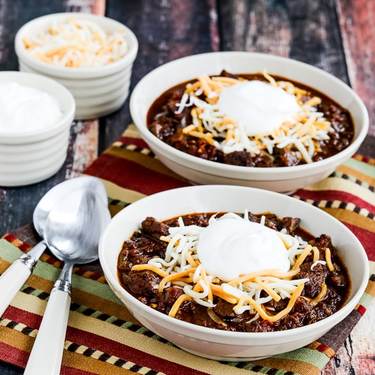 Instant Pot keto chili in bowls with cheese and sour cream