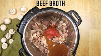 Pouring the beef broth into the Instant Pot 