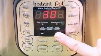 Hand pressing the Instant Pot timer