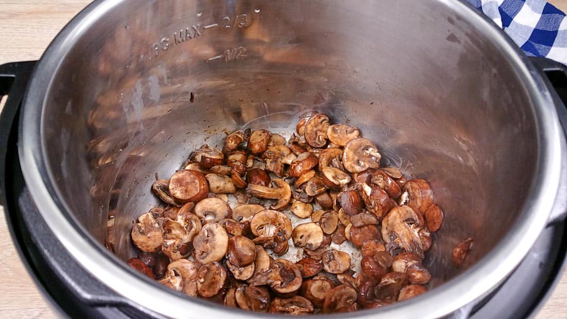 Sliced mushrooms being fried in the Instant Pot 