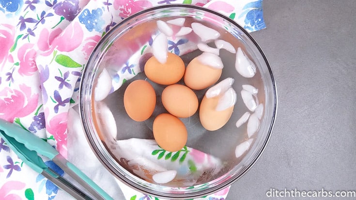 boiled eggs sitting in an ice water bath