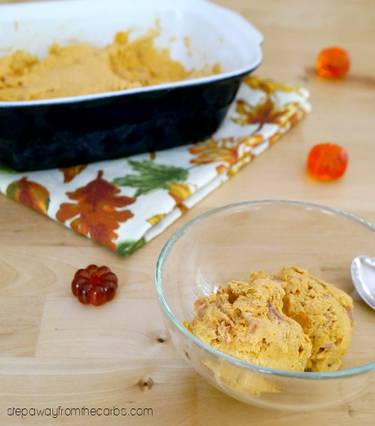 Sugar free pumpkin ice cream scooped and in a glass bowl