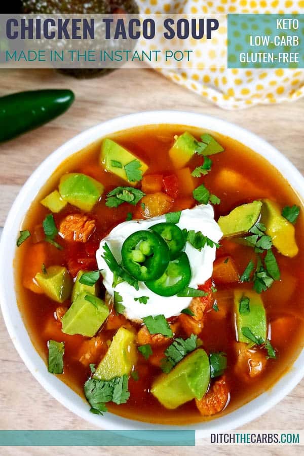 Low-carb Instant Pot chicken taco soup served in a white bowl and green napkin
