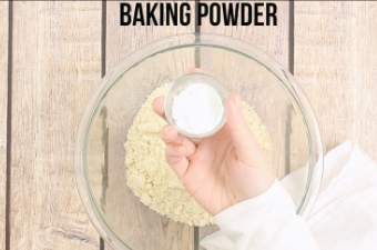 Adding baking powder to the mixing bowl