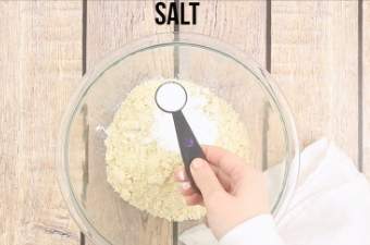 Adding salt to the mixing bowl