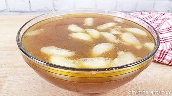 A bowl of bone broth with ice cubes