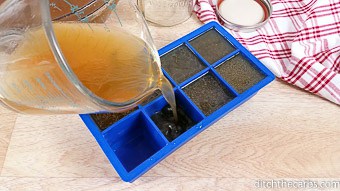 Bone broth being poured into ice cube trays