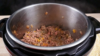 Ground beef being fried in the Instant Pot bowl