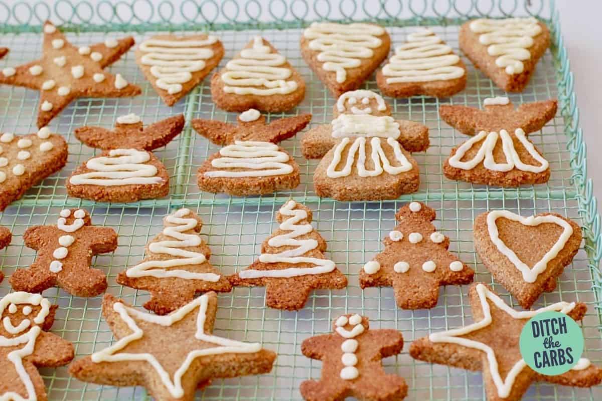 keto gingerbread cookies decorated on a wore cooling rack