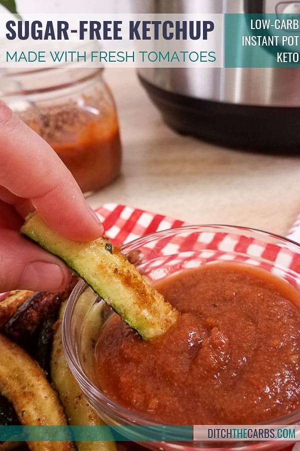 A person dipping cooked zucchini into home-made tomato sauce