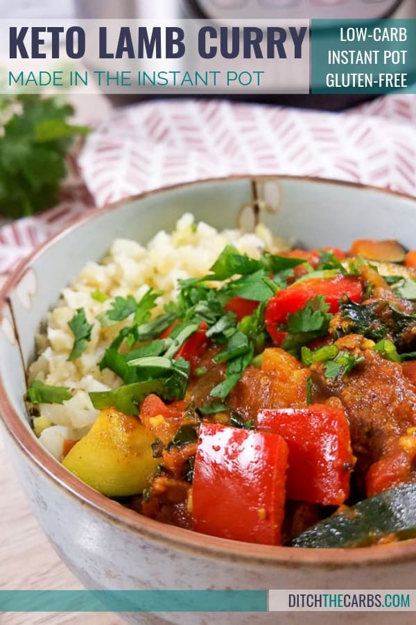 A bowl of low carb lamb curry and colourful vegetables with herbs