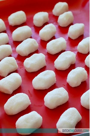 A close up of sugar-free coconut dairy free Easter eggs sitting on a baking tray about to be popped in the freezer