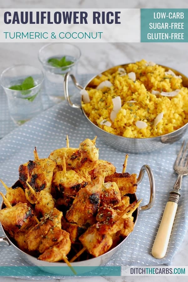 A tray of curry cauliflower rice with chicken skewers