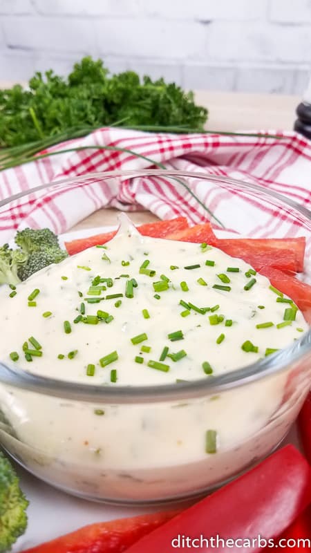 A bowl of magic one minute mayonnaise garnished with chopped chives