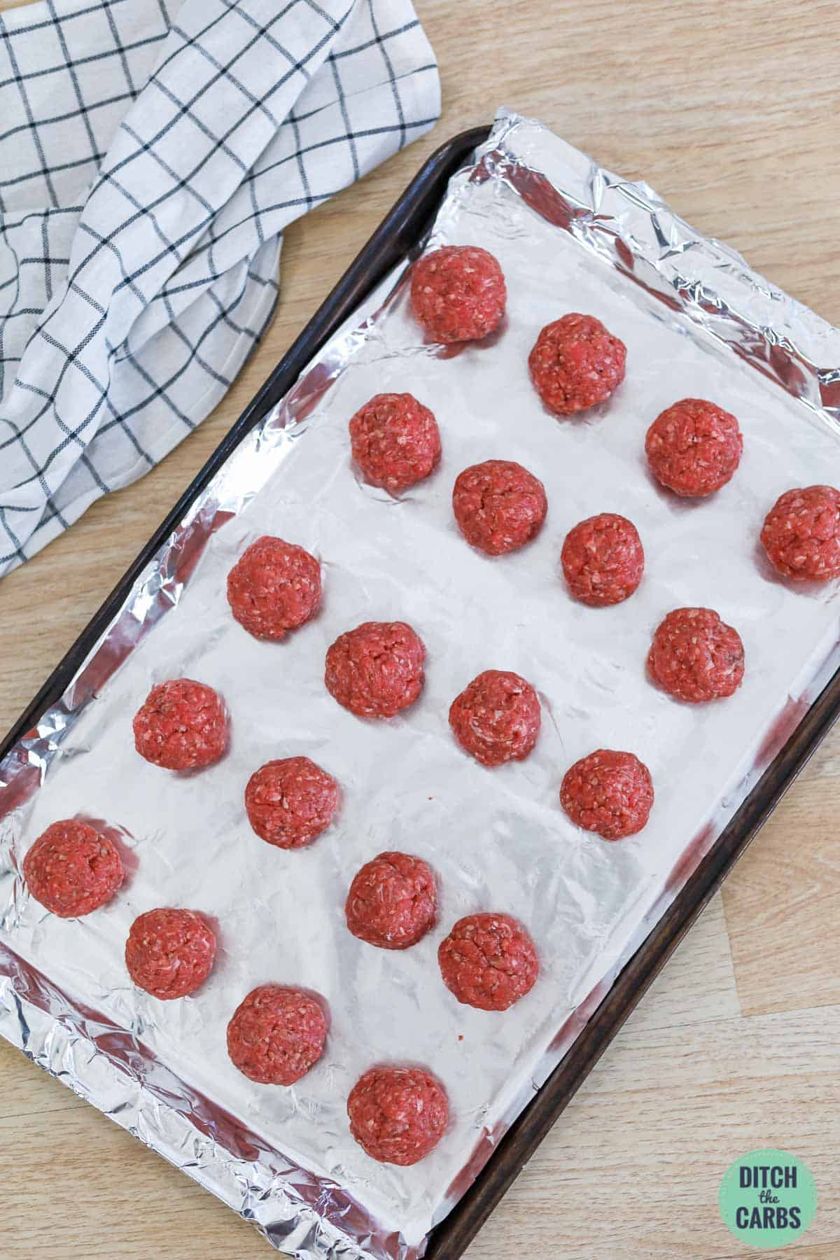 keto bacon meatballs on a lined baking sheet