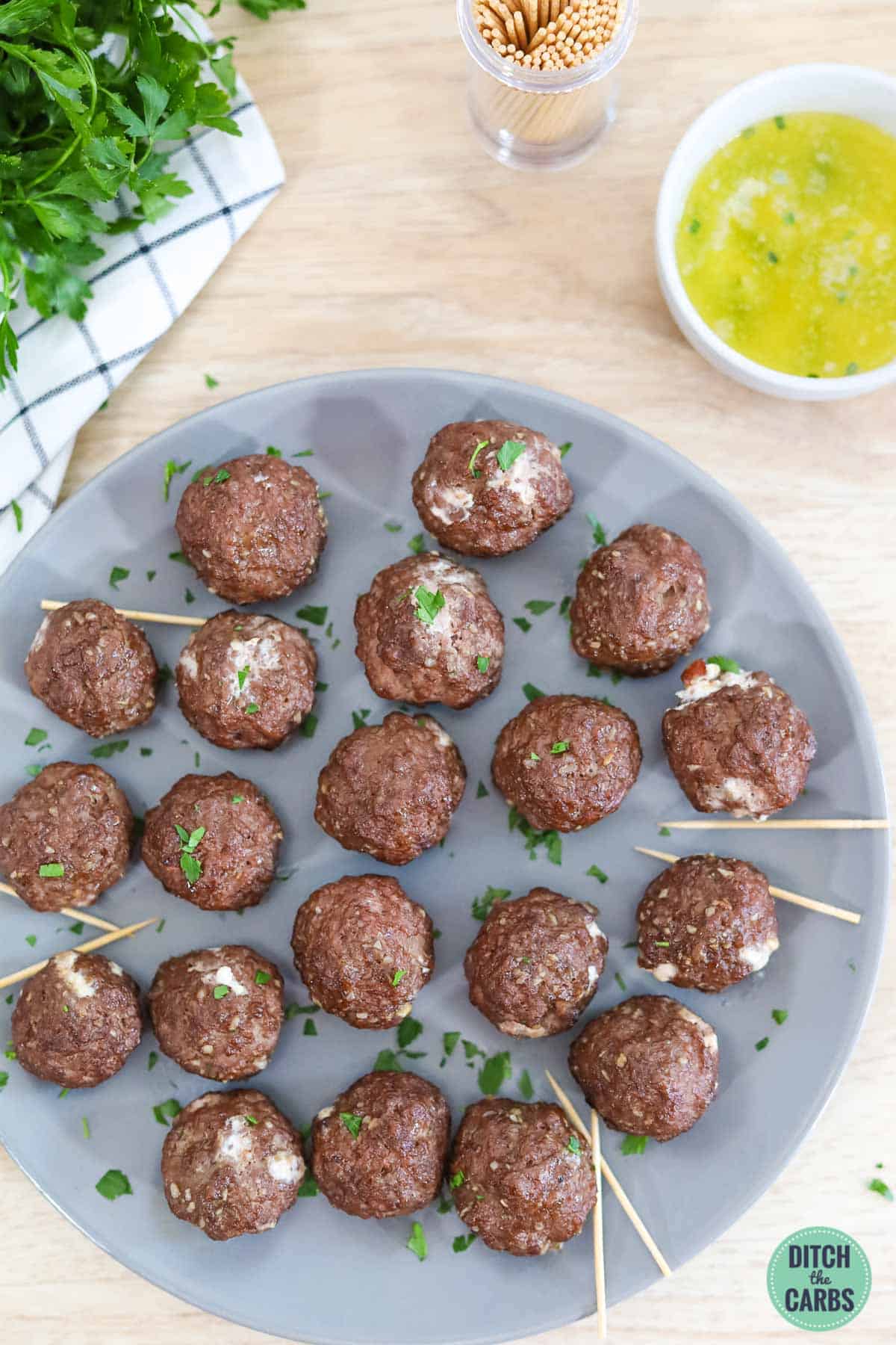 keto bacon meatballs on a grey platter with toothpicks